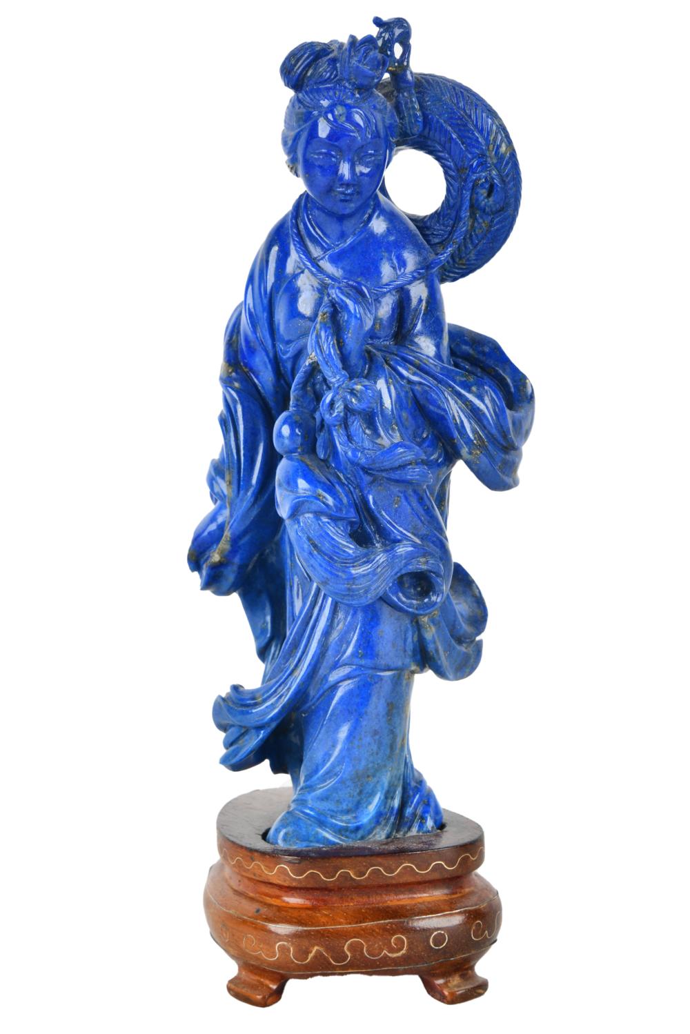 Appraisal: CHINESE CARVED LAPIS QUAN YIN FIGUREon a fitted wood base