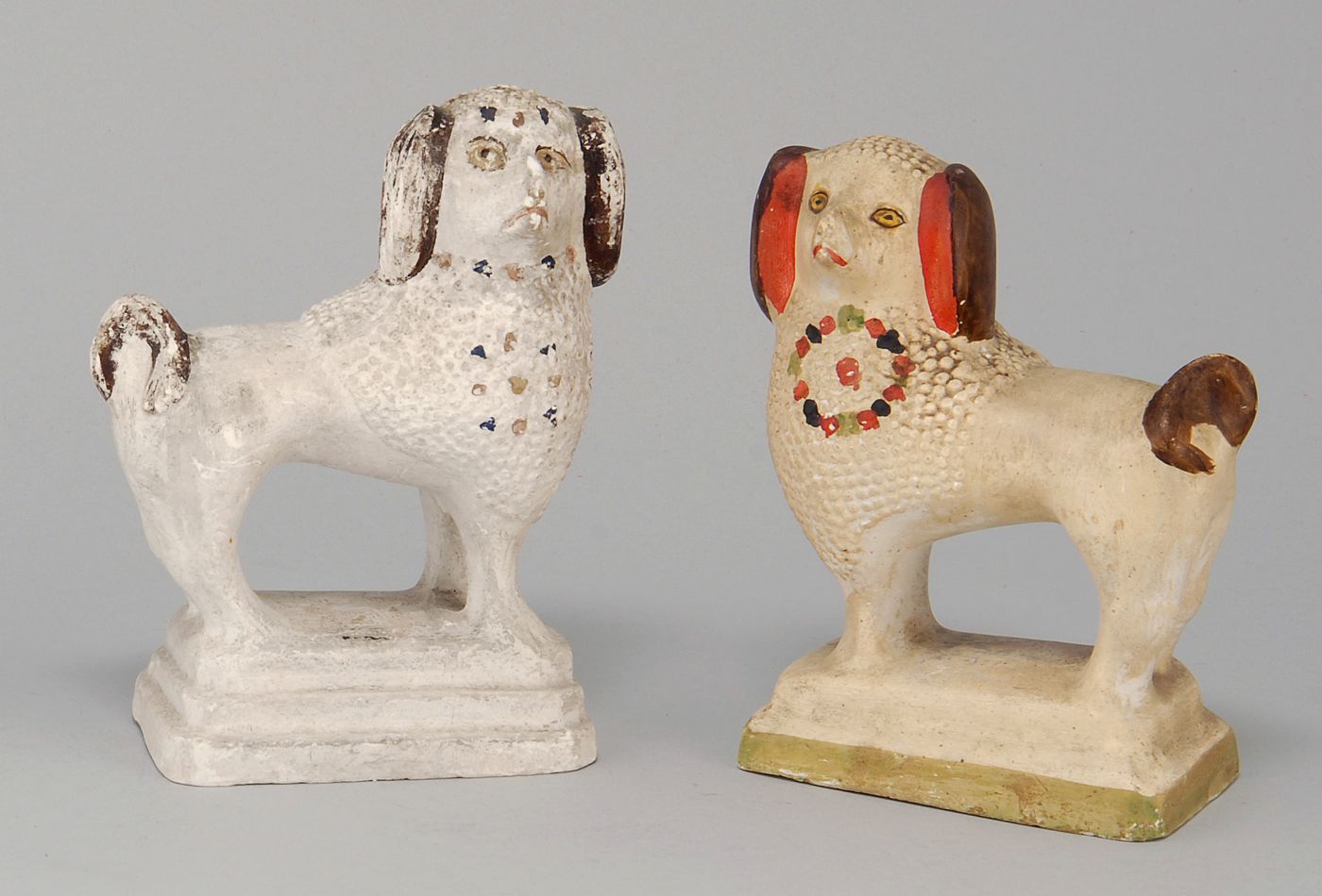 Appraisal: TWO CHALKWARE FIGURES Of standing spaniels Approximate heights Lengths Depths