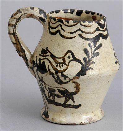 Appraisal: IVORY-GLAZED SMALL POTTERY JUG With tapered base and sloping shoulder