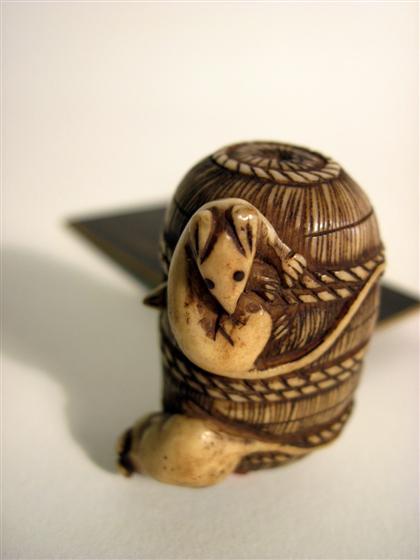 Appraisal: Group of four carved ivory itemsComprising a Japanese netsuke depicting