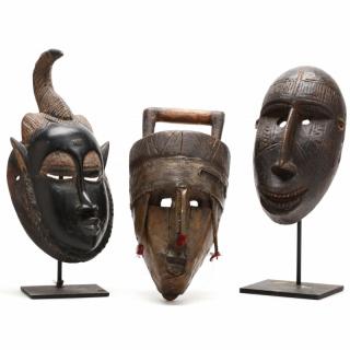 Appraisal: Three West African Masks carved wood the first with shiny