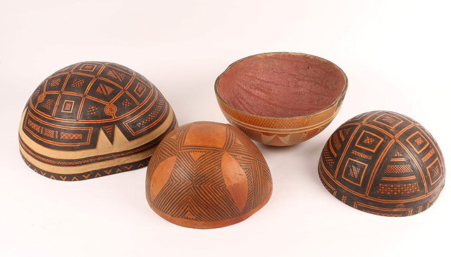 Appraisal: A GROUP OF FOUR NIGERIAN CALABASHES with stylised geometric decoration