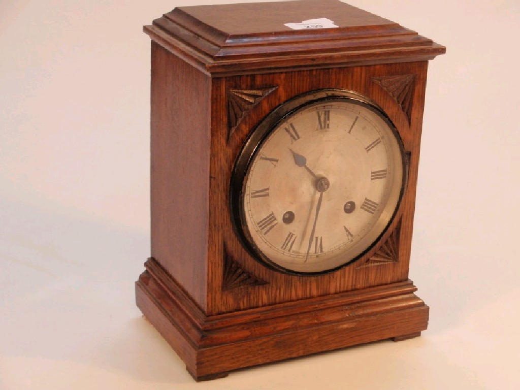 Appraisal: An Edwardian oak mantel clock with eight day chiming movement