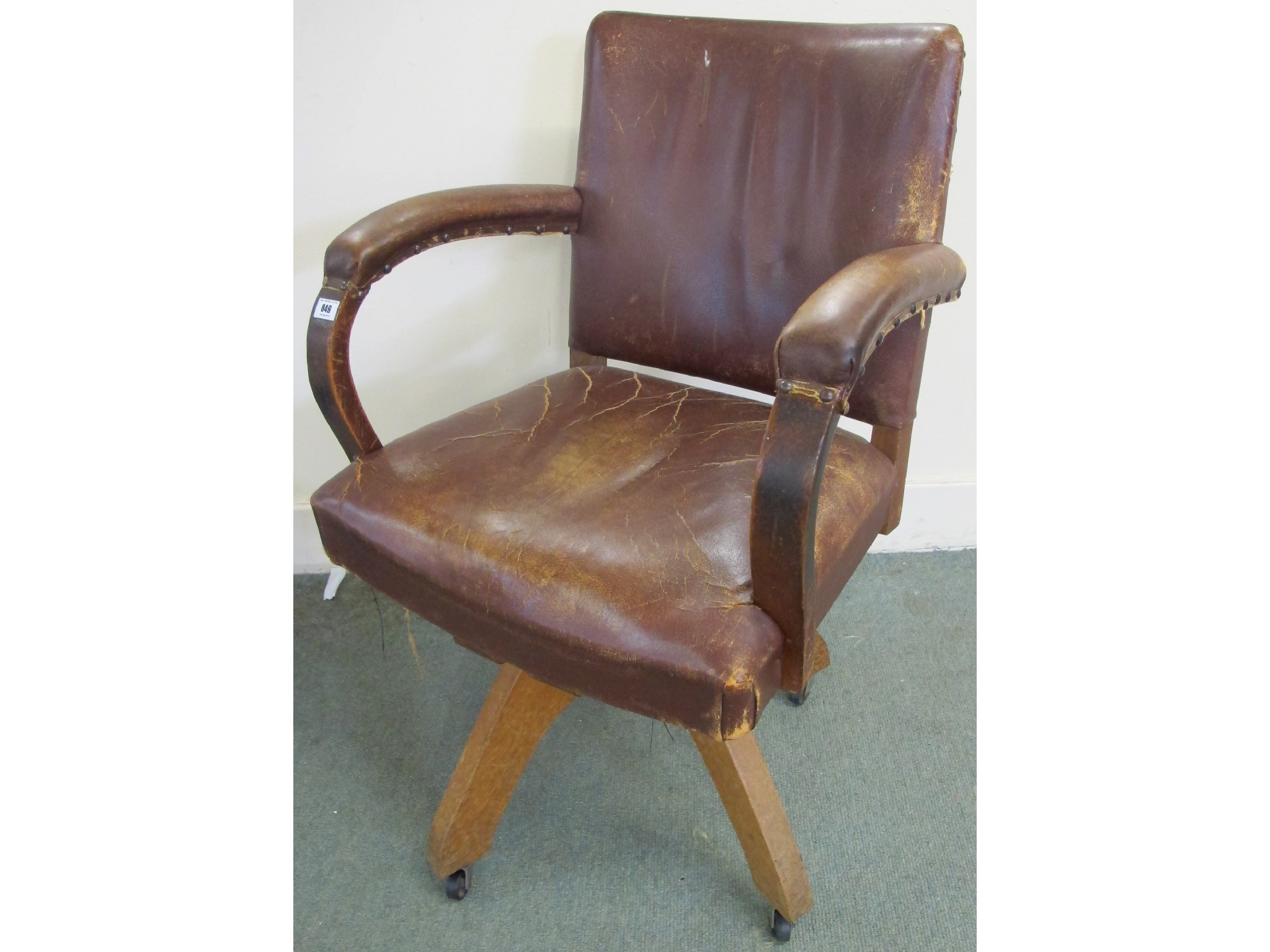 Appraisal: A mid- th Century oak and leather swivel office chair