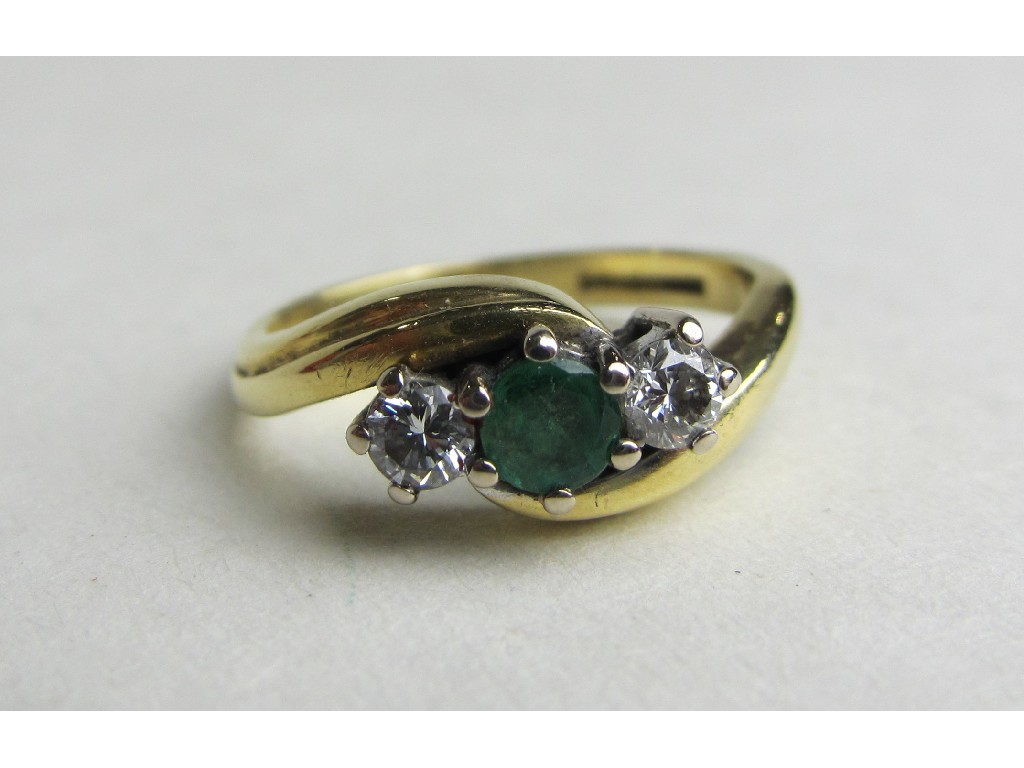 Appraisal: Eighteen carat gold emerald and diamond three stone twist ring