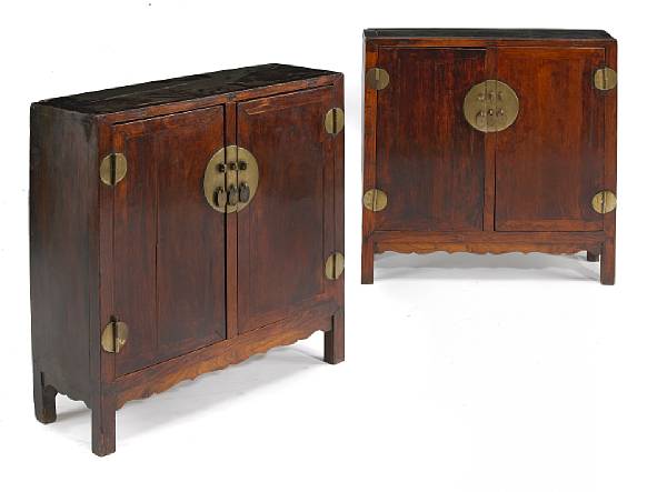 Appraisal: A pair of small huanghuali and mixed wood two-door cabinets