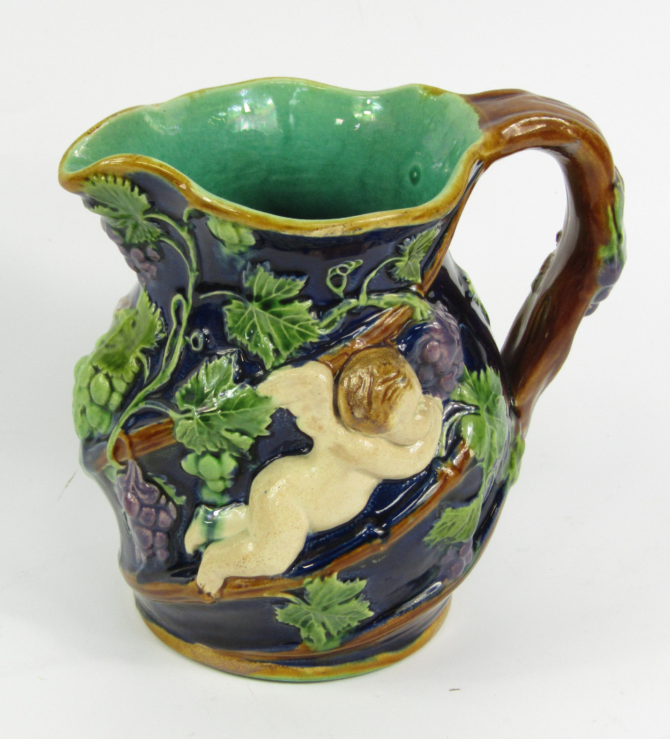 Appraisal: A Victorian Minton majolica bacchanalian jug spirally moulded and decorated