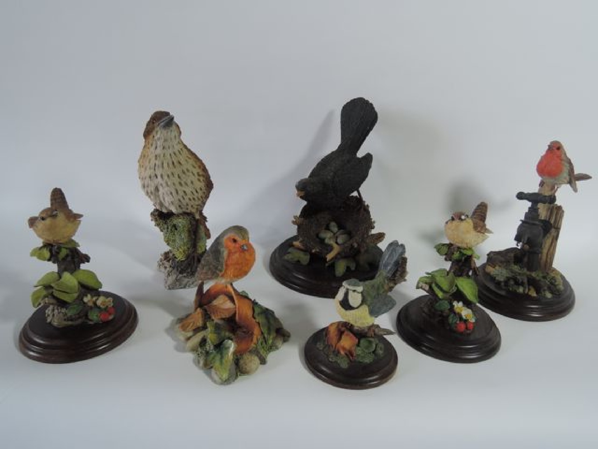 Appraisal: A collection of seven cast resin models of garden birds