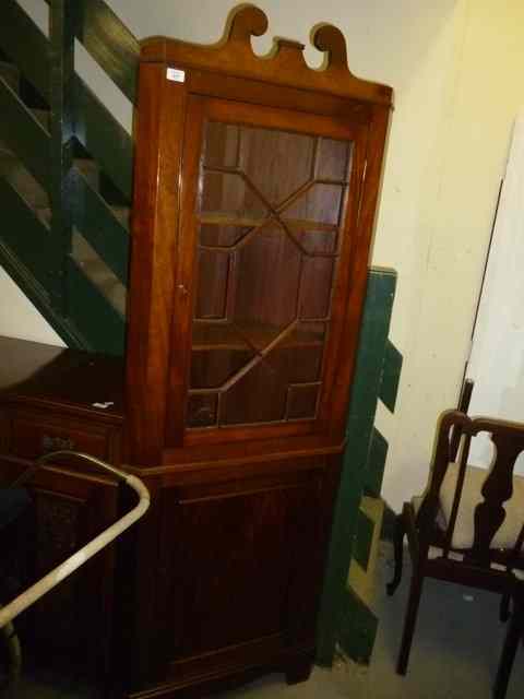 Appraisal: A MAHOGANY FLOOR STANDING CORNER DISPLAY CABINET with swan neck