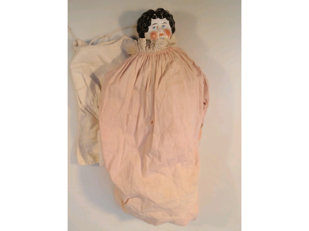 Appraisal: A ceramic headed doll with painted features kid leather body