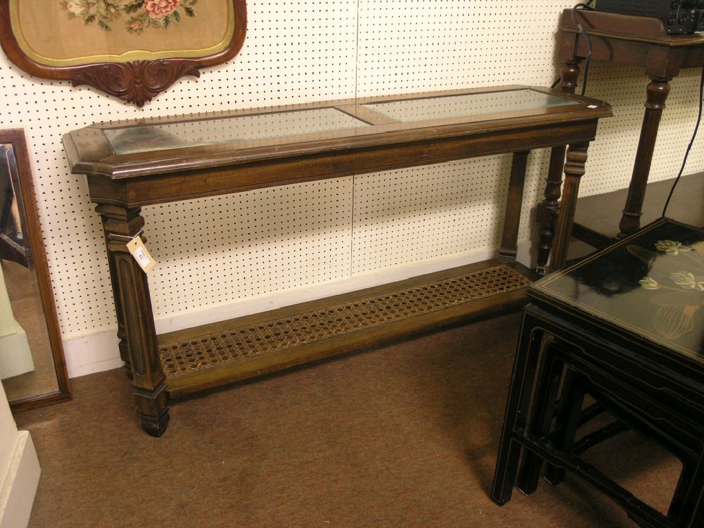 Appraisal: A walnut hall table with inset glass to the top