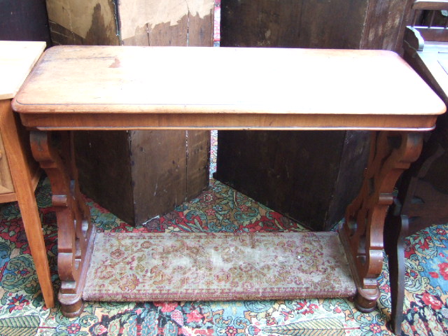 Appraisal: A Victorian mahogany side table raised on a pair of