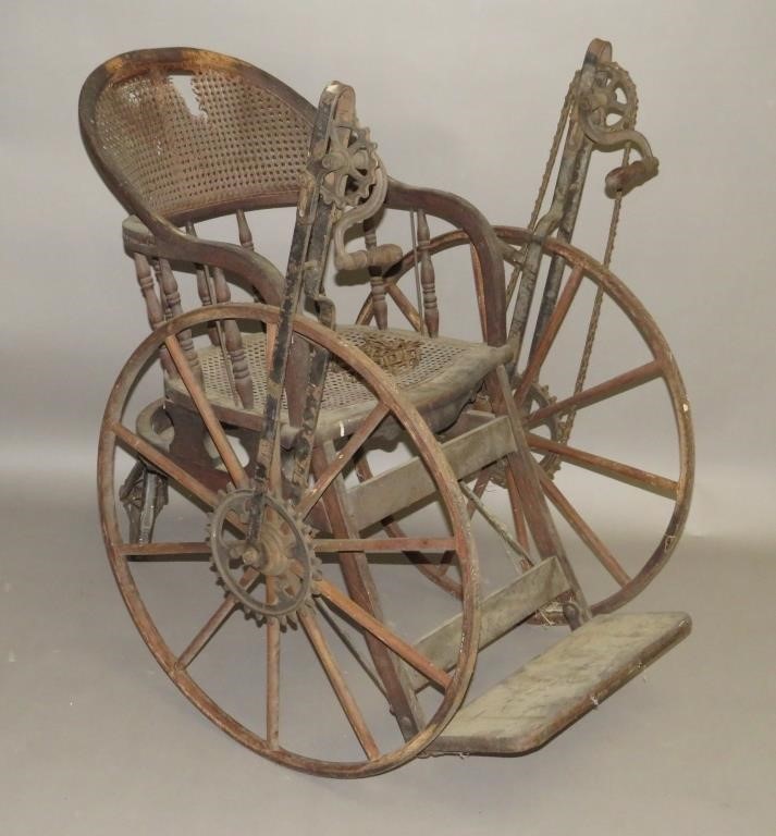 Appraisal: WHEELCHAIRca hand actuated by using handles to turn the chain