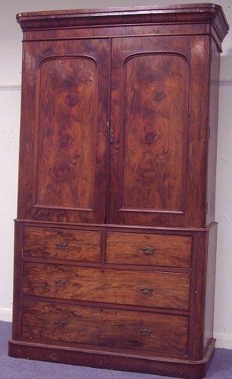 Appraisal: A late Victorian walnut linen press with moulded cornice fitted