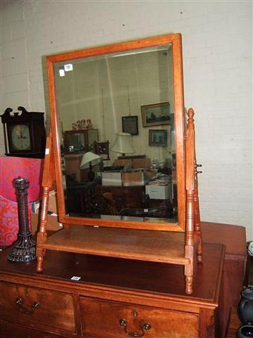 Appraisal: An oak Arts and Crafts style swing toilet mirror high