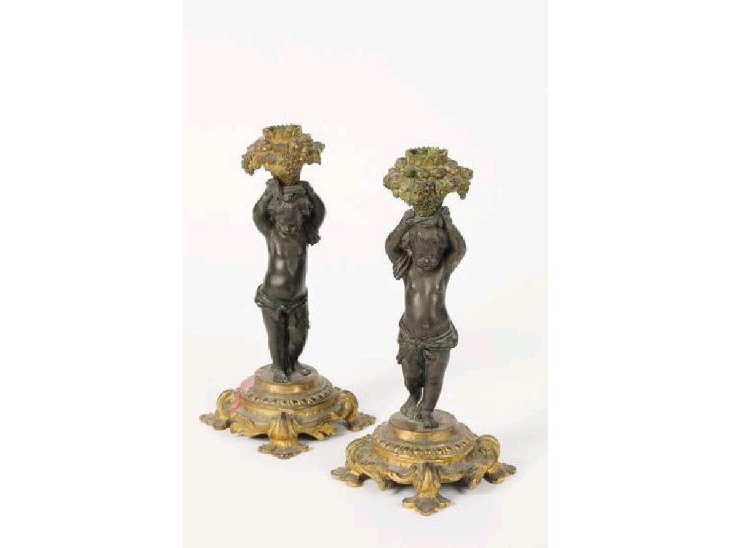 Appraisal: A PAIR OF ROCOCO STYLE ORMOLU MOUNTED CANDLESTICKS in the