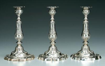 Appraisal: Three weighted sterling candlesticks round with scroll and floral decoration