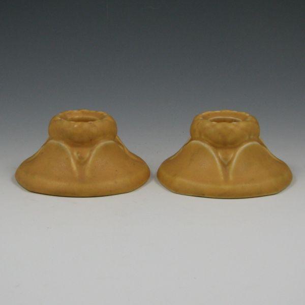 Appraisal: Rookwood candleholders in matte yellow Both marked with Rookwood logo