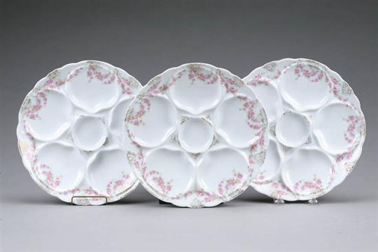 Appraisal: THREE LIMOGE OYSTER PLATES Five wells with gilt and floral