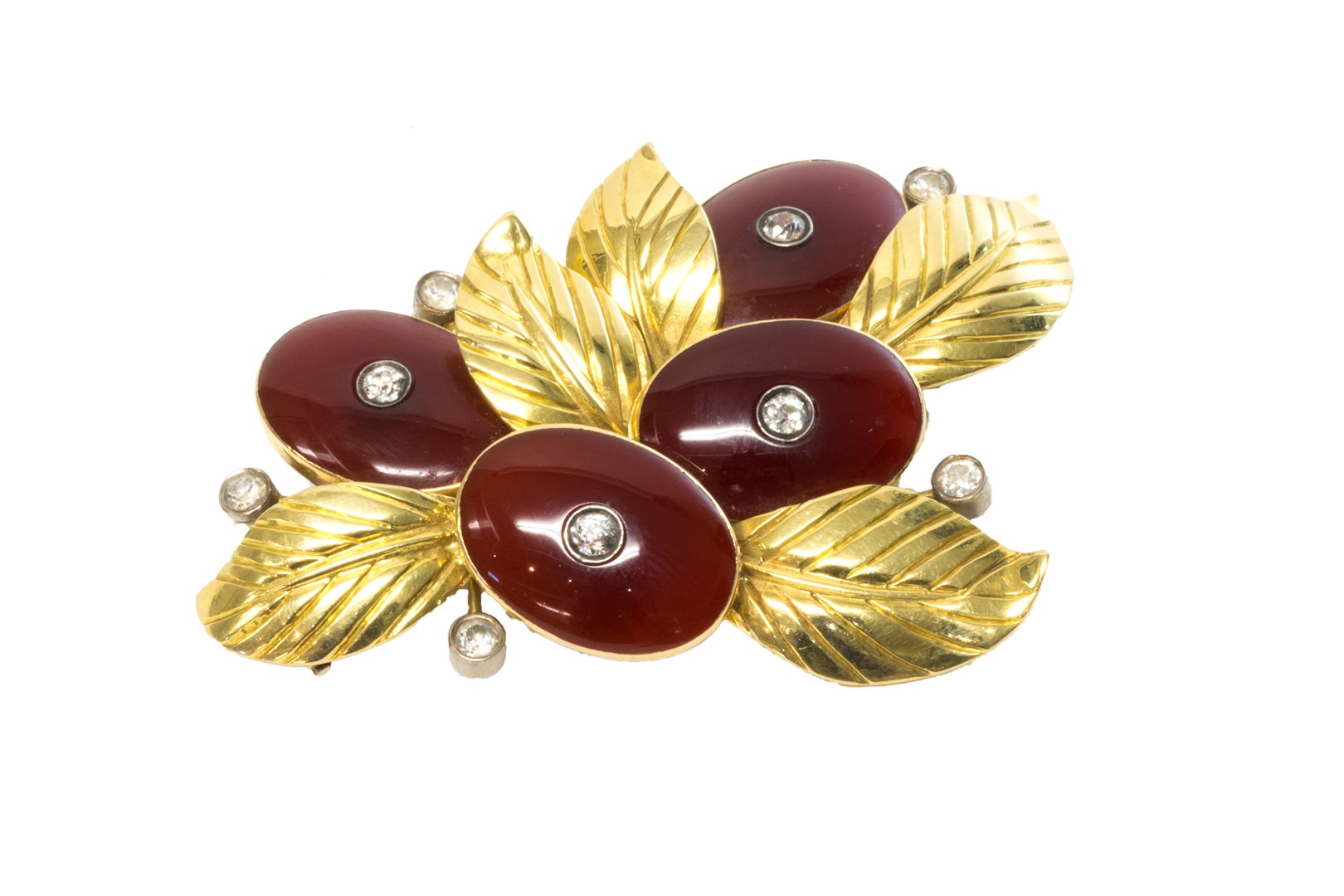 Appraisal: A gold diamond and cornelian set brooch in a foliate