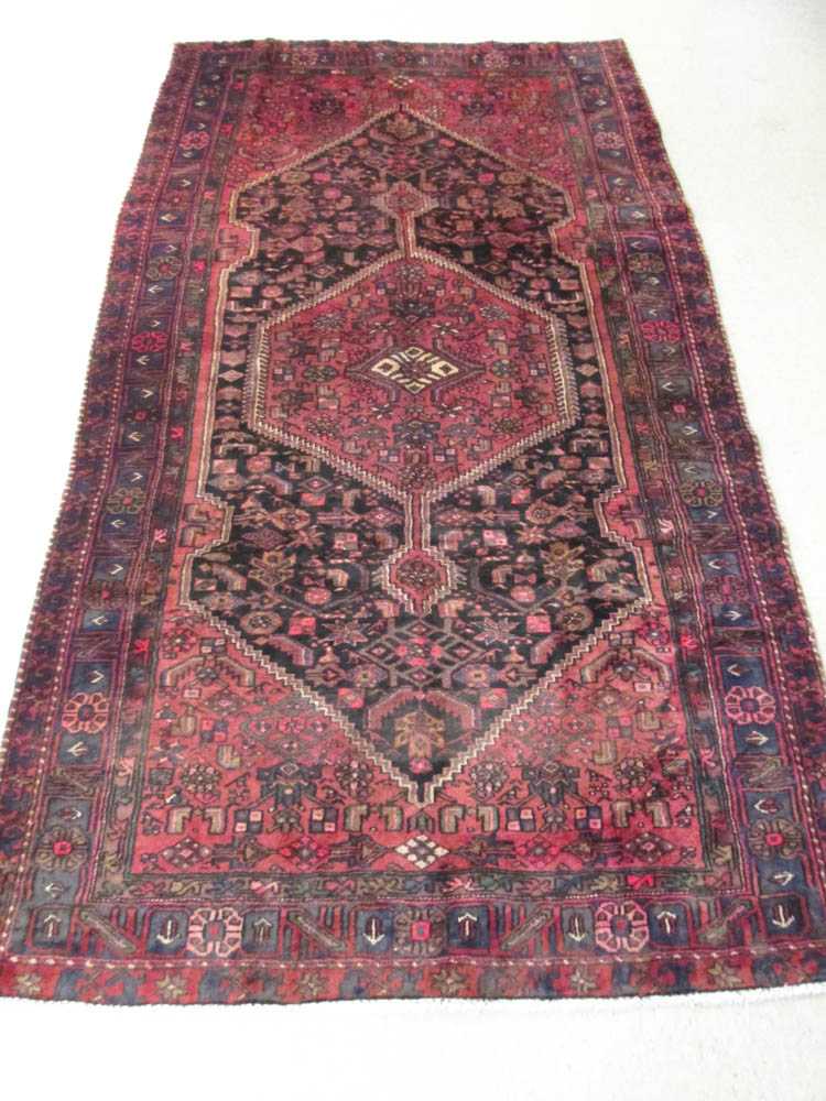 Appraisal: SEMI-ANTIQUE PERSIAN TRIBAL AREA RUG the central hexagonal red medallion