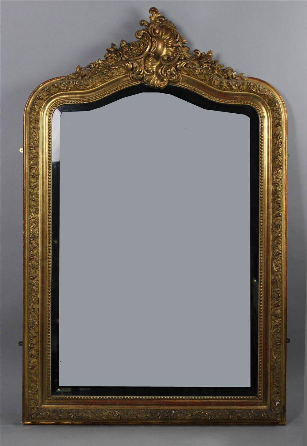 Appraisal: ROCOCO STYLE CARVED GILTWOOD MIRROR the carved giltwood and rocaille