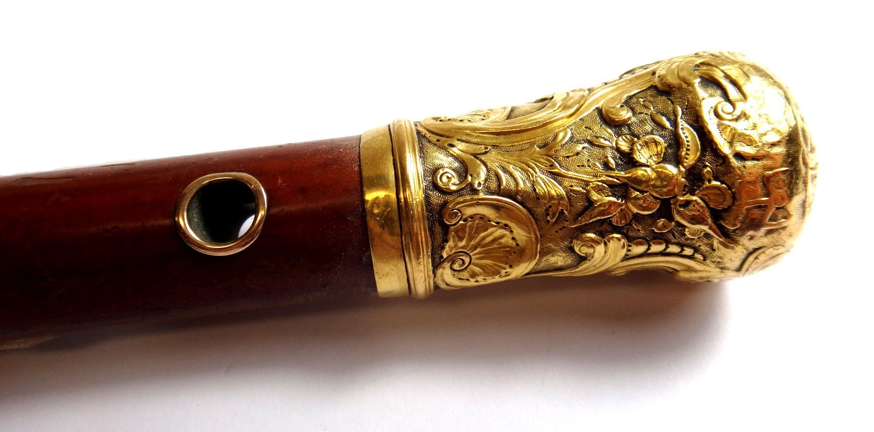 Appraisal: A gold topped Malacca walking cane with rococo scrolling and