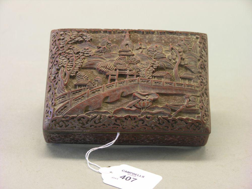 Appraisal: A Japanese cinnebar lacquer box intricately carved with a riverscape