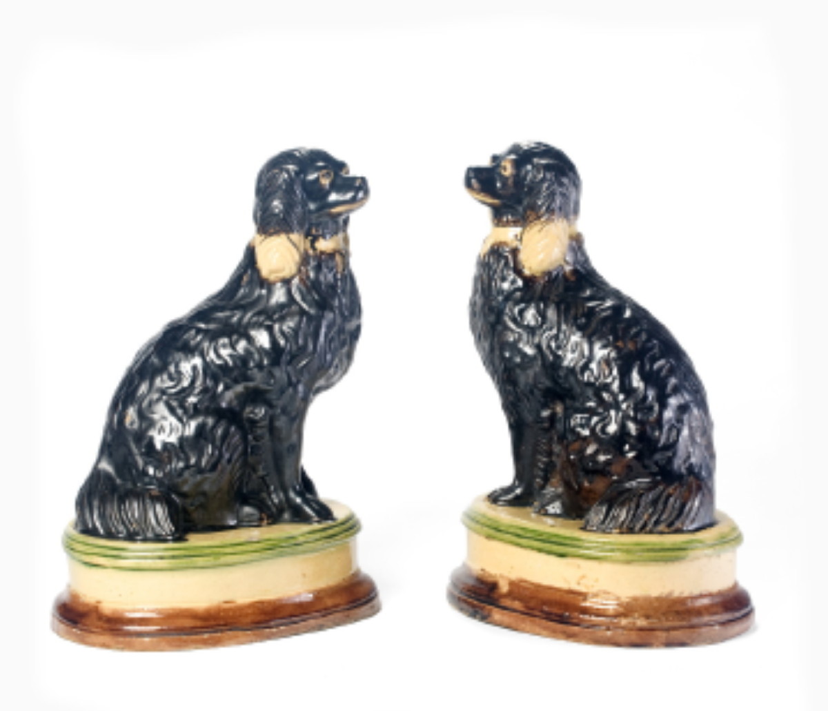 Appraisal: PAIR OF AMERICAN YELLOW WARE FIGURES OF SEATED SPANIELS OHIO