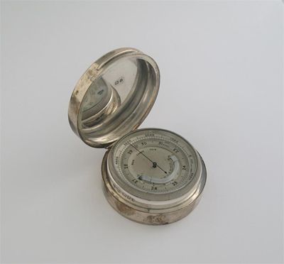 Appraisal: A modern circular pocket aneroid barometer and thermometer combined hinged