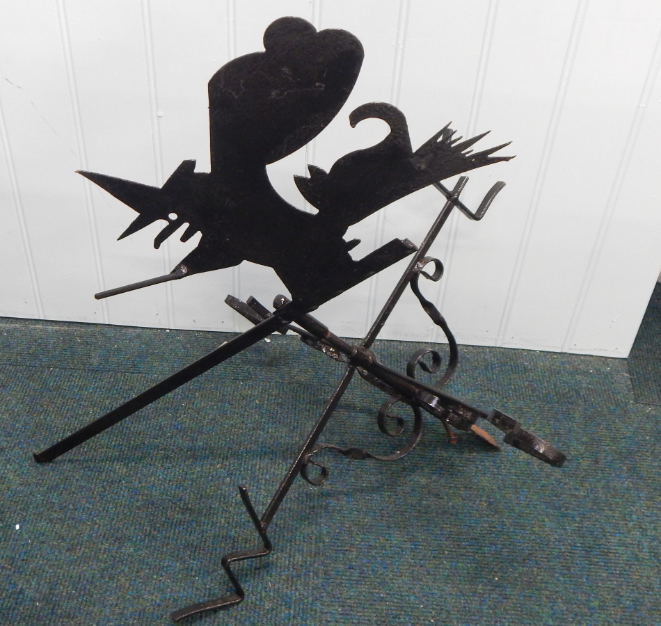 Appraisal: A modern wrought iron weather vane decorated to the top