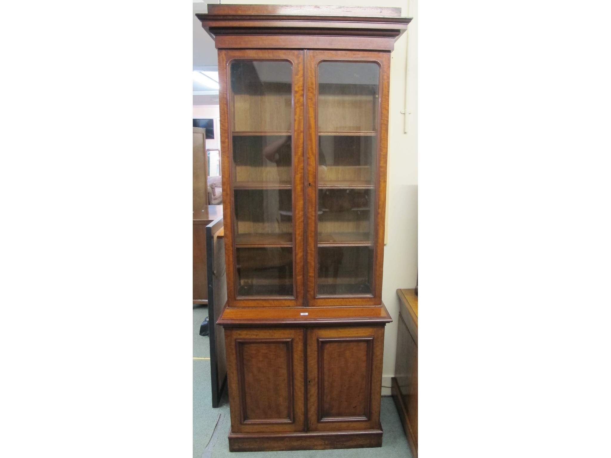 Appraisal: A Victorian mahogany glazed bookcase on cupboard