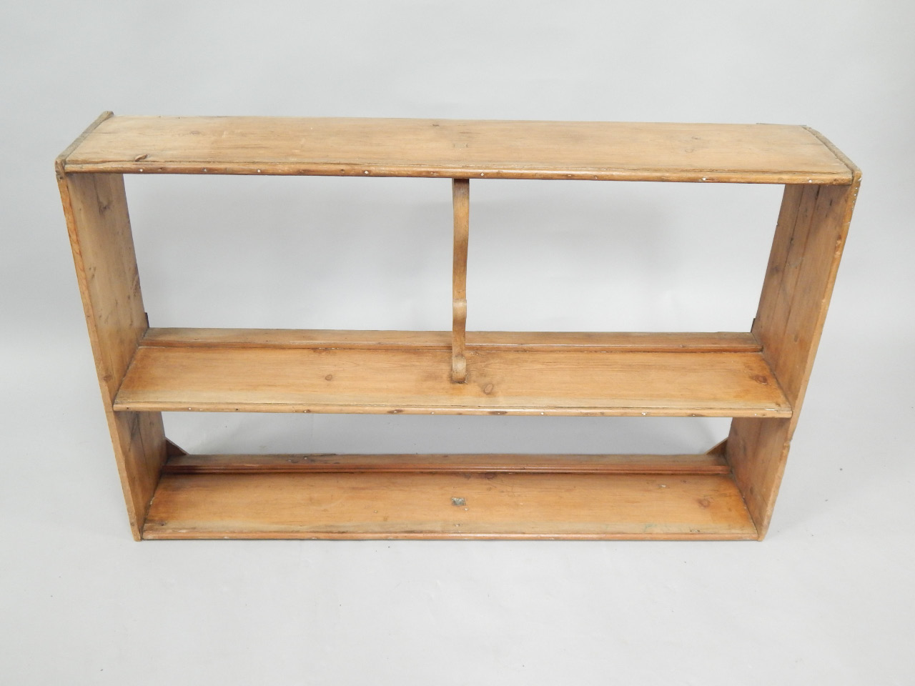 Appraisal: A pine plate rack with two shelves and scroll supports