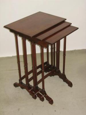 Appraisal: A NEST OF THREE MAHOGANY TABLES of oblong form crossbanded