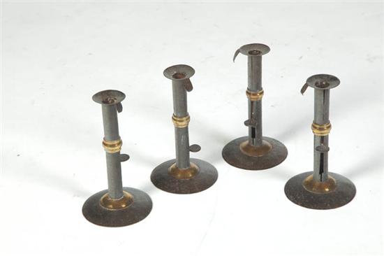 Appraisal: FOUR HOGSCRAPER CANDLESTICKS Probably American th century Each has a