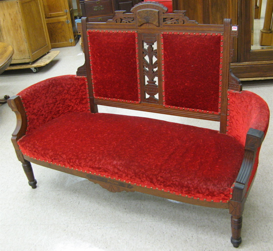 Appraisal: VICTORIAN SETTEE Eastlake design c with walnut frame and crushed