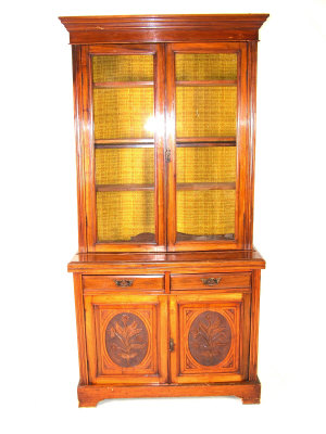 Appraisal: A Victorian walnut bookcase with moulded cornice above glazed doors