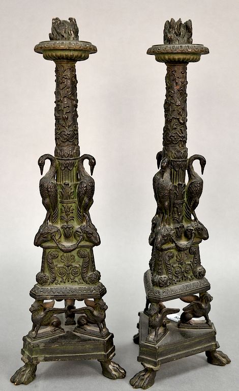 Appraisal: Pair of bronze candlesticks with flaming nozzle over foliate shaft