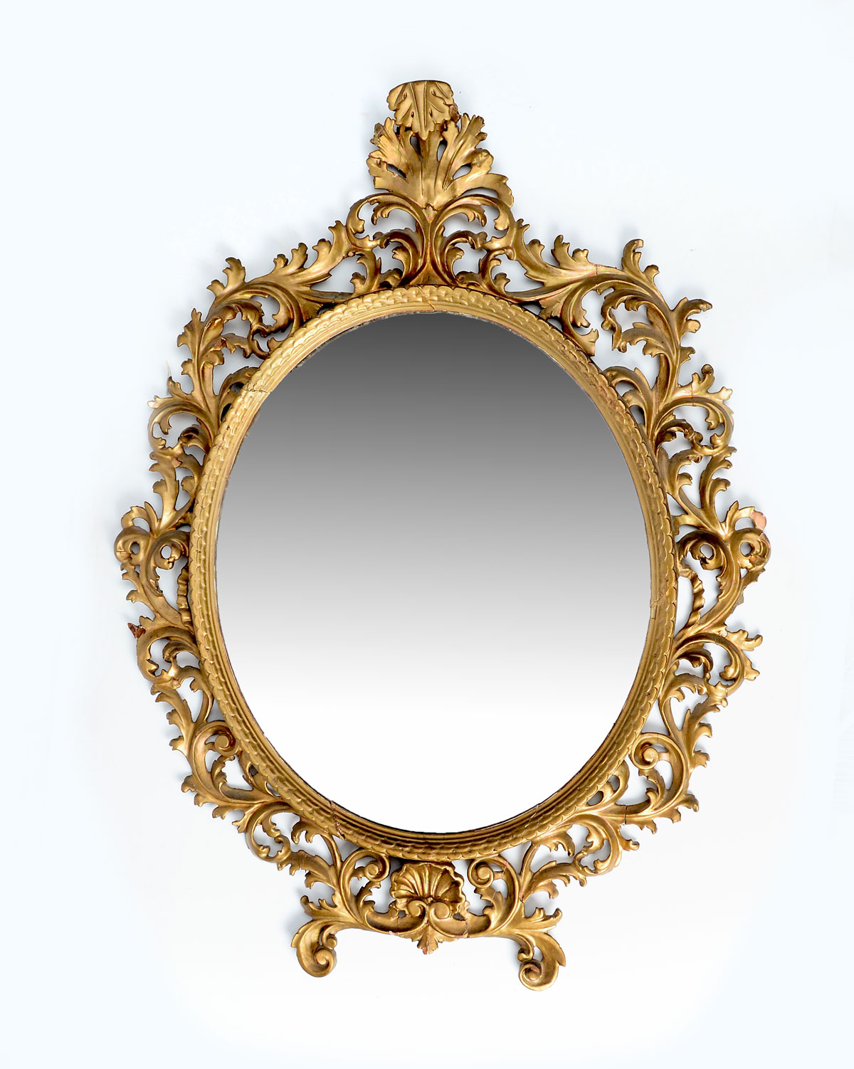 Appraisal: FLORENTINE CARVED MIRROR Oval beveled glass mirror with an encompassing