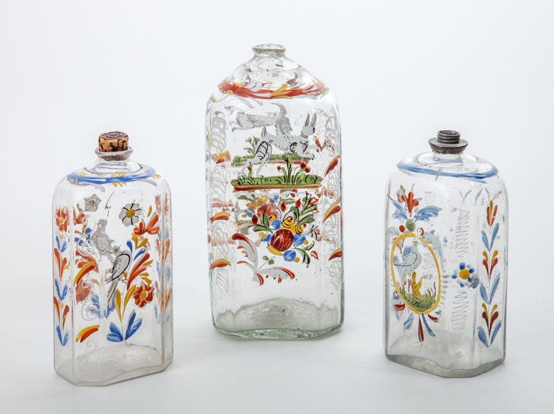 Appraisal: THREE STIEGEL TYPE ENAMEL-DECORATED GLASS BOTTLES to in Estimate -