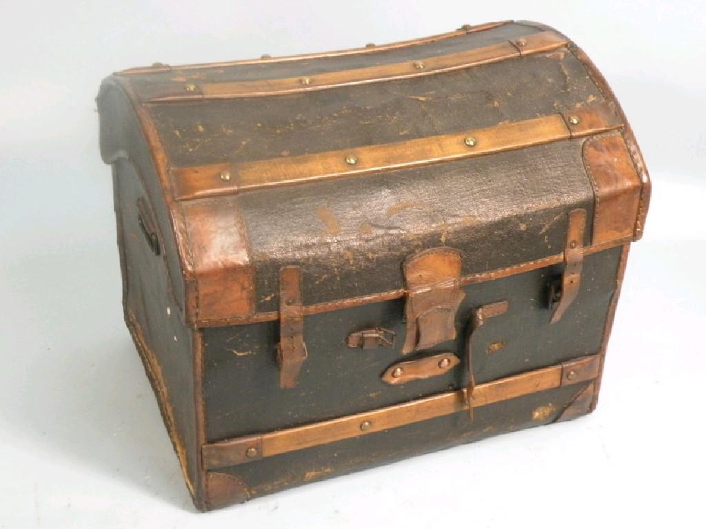 Appraisal: A canvas and leather trunk by W Insall Sons of