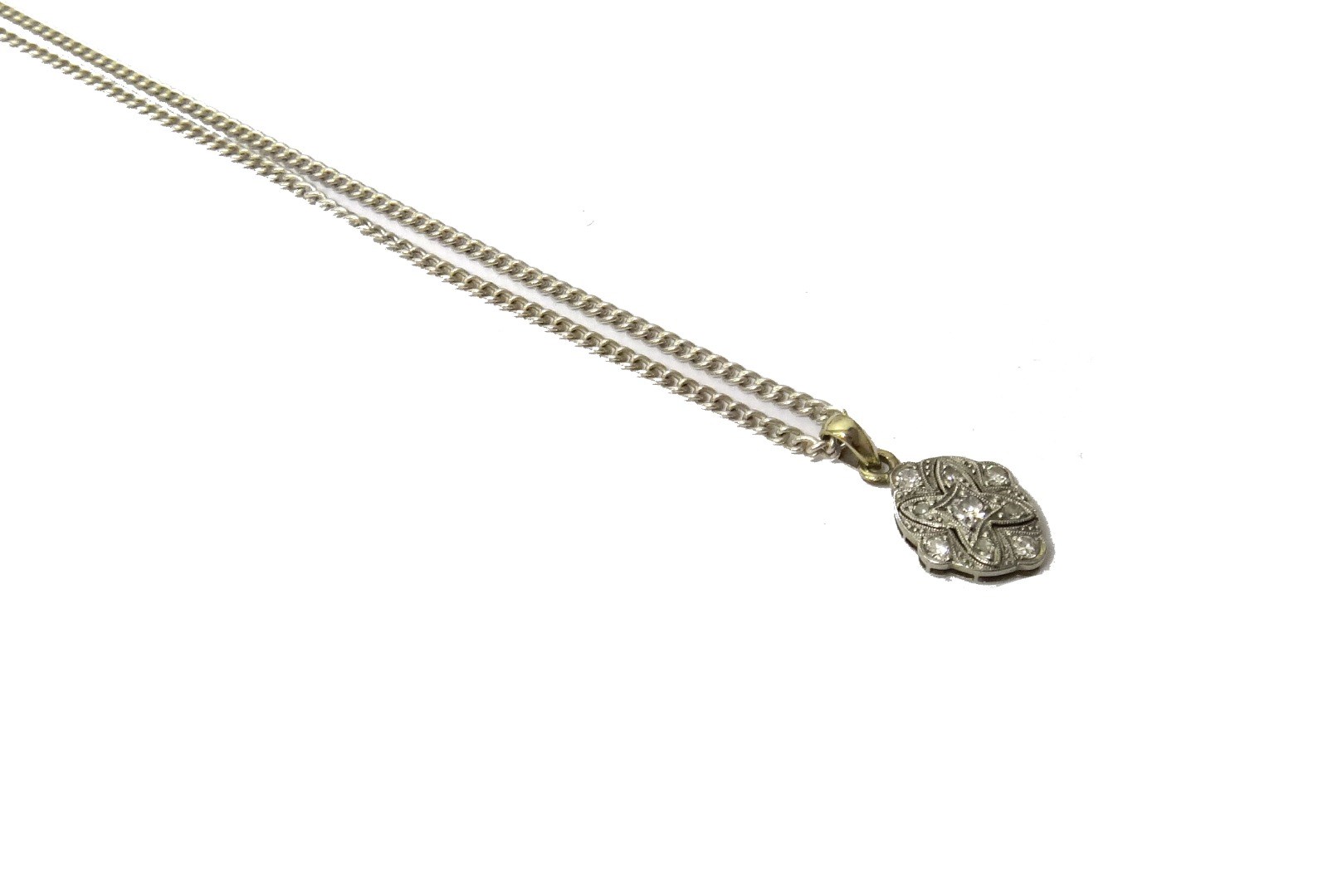 Appraisal: A white gold and platinum diamond set pendant in a