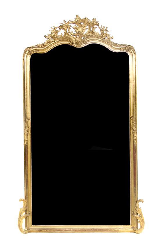 Appraisal: French Giltwood Mirror the shaped plate beneath a carved crest