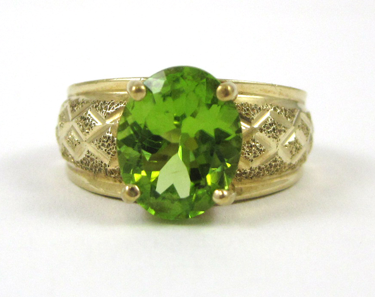 Appraisal: PERIDOT AND TEN KARAT YELLOW GOLD RING set with an