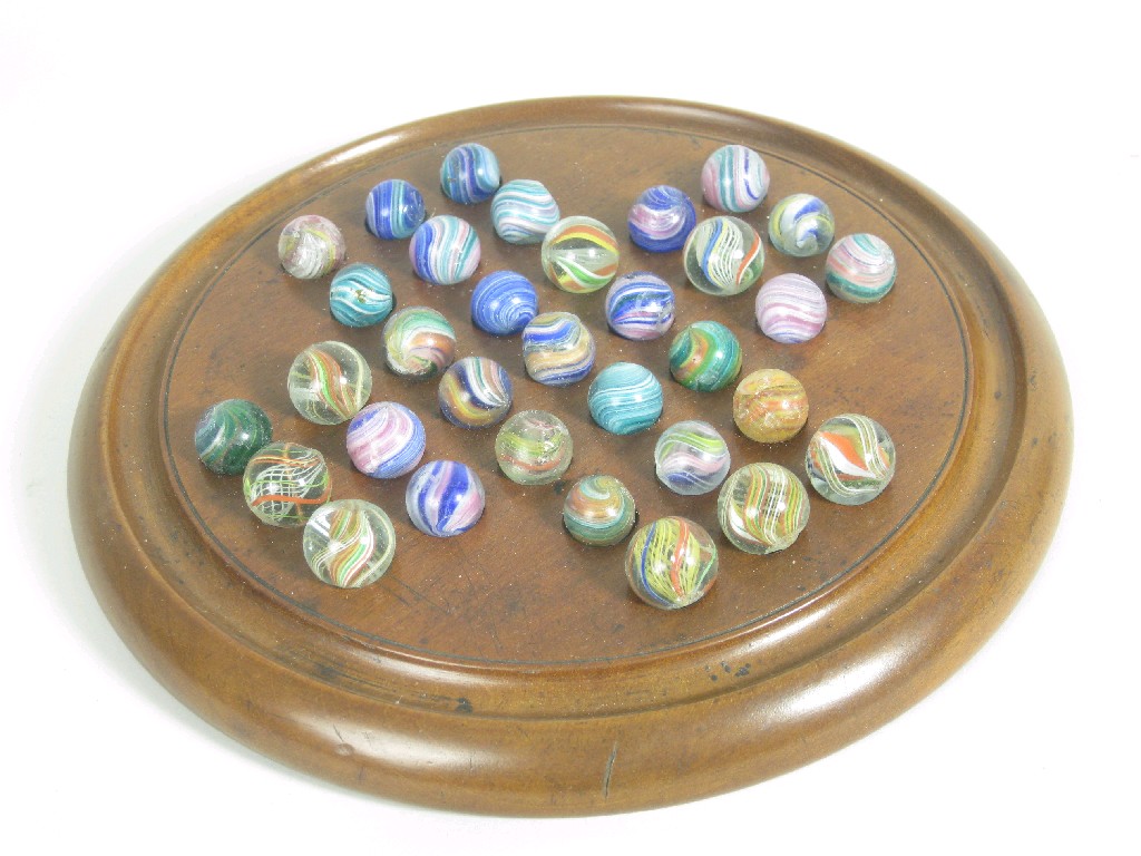 Appraisal: A Solitaire Board with glass marbles and an inlaid folding