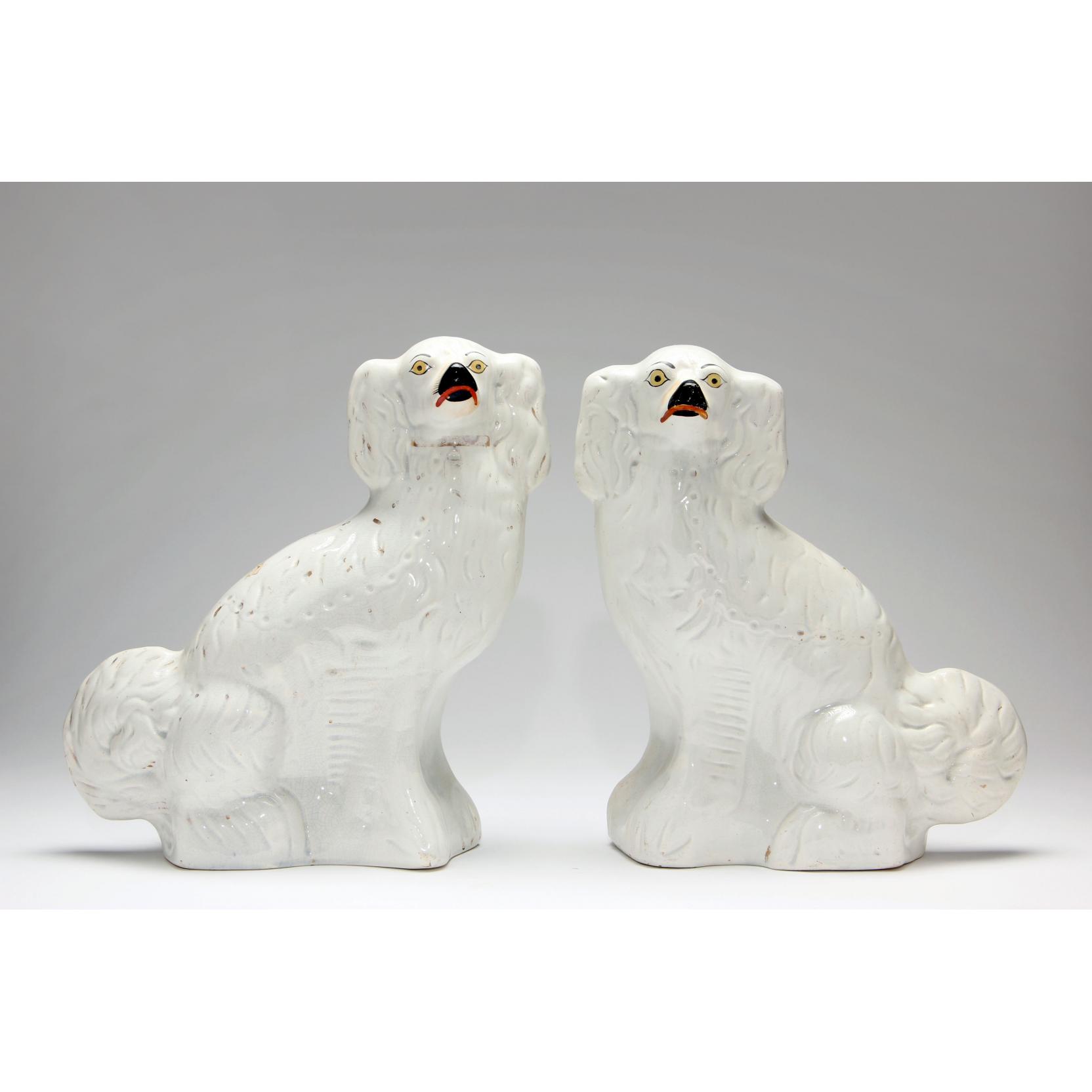 Appraisal: Pair of Staffordshire Spaniels th century white with gilt painted