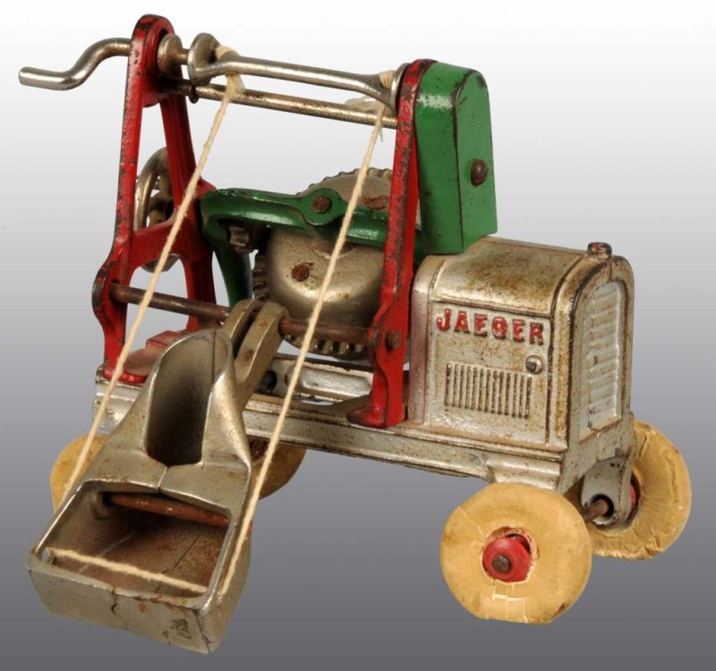 Appraisal: Cast Iron Jaeger Mixer Toy Description Circa Has rubber tires