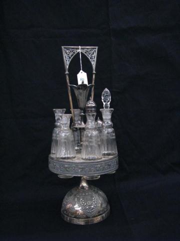 Appraisal: Victorian Aesthetic Movement six-bottle silverplated castor set