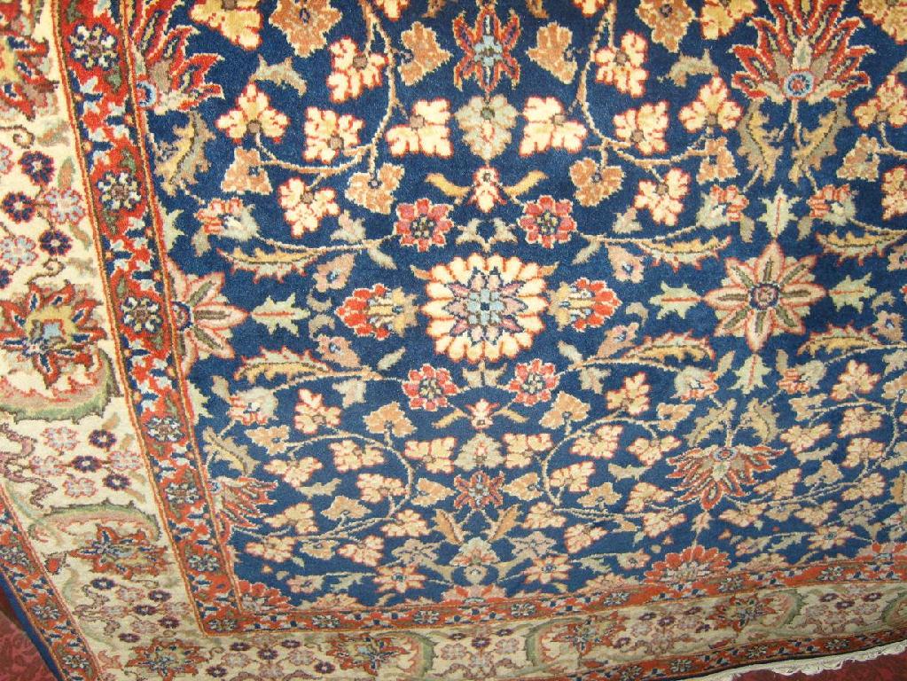 Appraisal: A blue ground eastern wool rug with stylised floral decoration