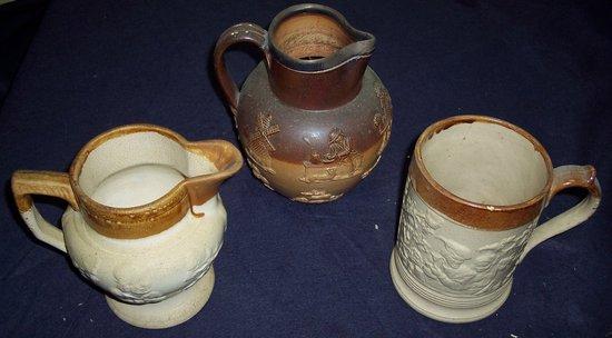 Appraisal: A brown glazed stoneware jug with plated mounts and two